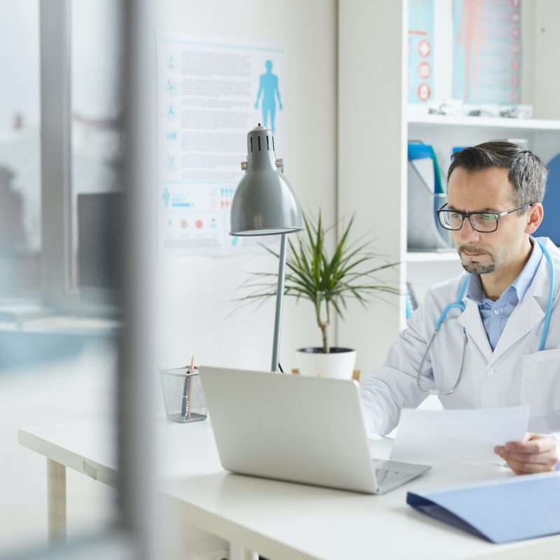 Doctor working on laptop at office